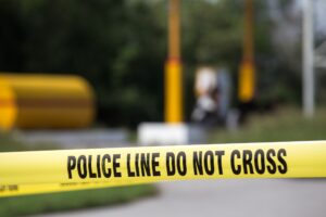 A close up image of police tape with a blurred background.